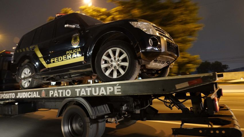 A fake police truck that was used in robbery is transported on a flat-bed truck in Sao Paulo, Brazil, Thursday, July 25, 2019. Authorities at Sao Paulo's Guarulhos international airport say eight armed men raided a terminal and escaped with some 750 kilos of gold. (AP Photo/Victor R. Caivano)