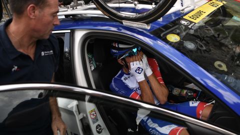 France's Thibaut Pinot, in his team car, reacts after quitting the Tour de France.