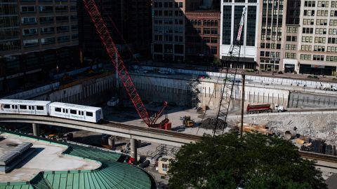 The People Mover, an above-ground transit system built in the the late 1980s, circles downtown Detroit as construction crews work on Hudon's site, a mix-used development. It is planned to be the tallest building in Michigan's history.
