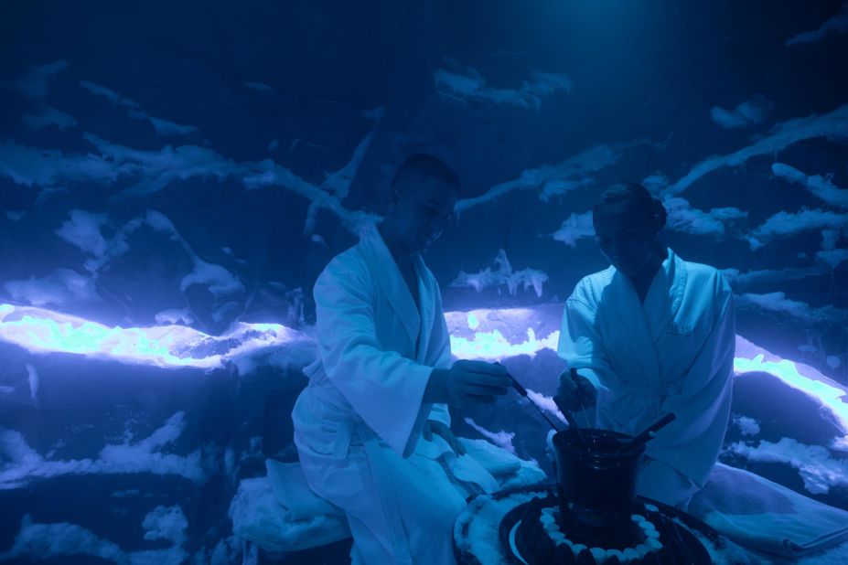 Here, two visitors at the spa cool off in the ice room with cheese and chocolate fondue.