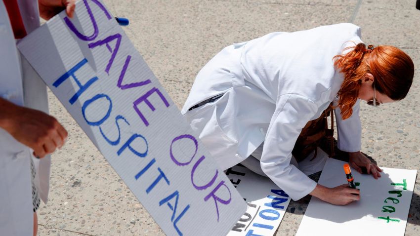 Dr. Angela Silverman makes a placard before joining a demonstration against the planned closure of Hahnemann University Hospital, at City Hall in Philadelphia, Thursday, June 27, 2019. The owner of hospital has announced it will close in September because of what the company calls "continuing, unsustainable financial losses."(AP Photo/Matt Rourke)