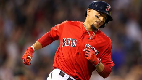 The Red Sox's Mookie Betts rounds first base after he hits a two-run home run, his third of the game,  in the fourth inning against the New York Yankees on Friday.