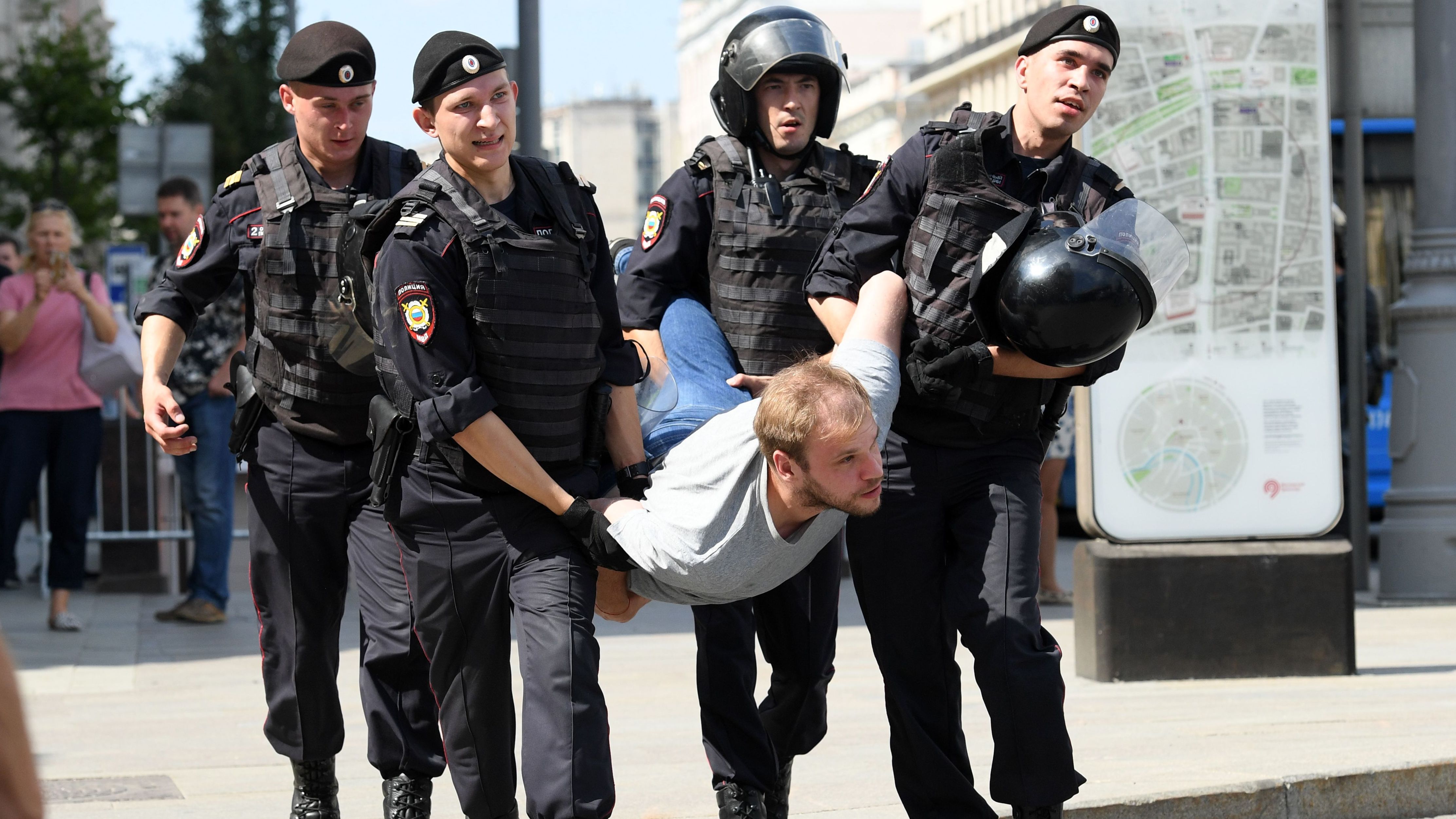 Police officers detain a man during an unauthorized rally demanding free and fair elections outside the mayor's offices in Moscow on July 27, 2019. 