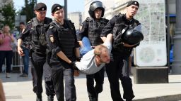 Police officers detain a man during an unauthorized rally demanding free and fair elections, outside the mayor's offices in Moscow on July 27, 2019. 