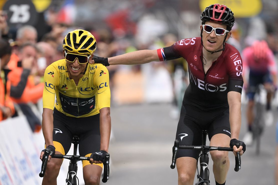 Egan Bernal, wearing the overall leader's yellow jersey, is congratulated by teammate Geraint Thomas.