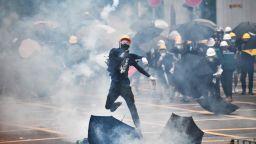 A protester throws tear gas back at police officers during a demonstration in the district of Yuen Long in Hong Kong on July 27, 2019. - Riot police fired tear gas at protesters marching through a Hong Kong town near the Chinese border to rally against suspected triad gangs who beat up pro-democracy demonstrators there last weekend. (Photo by Anthony WALLACE / AFP)        (Photo credit should read ANTHONY WALLACE/AFP/Getty Images)