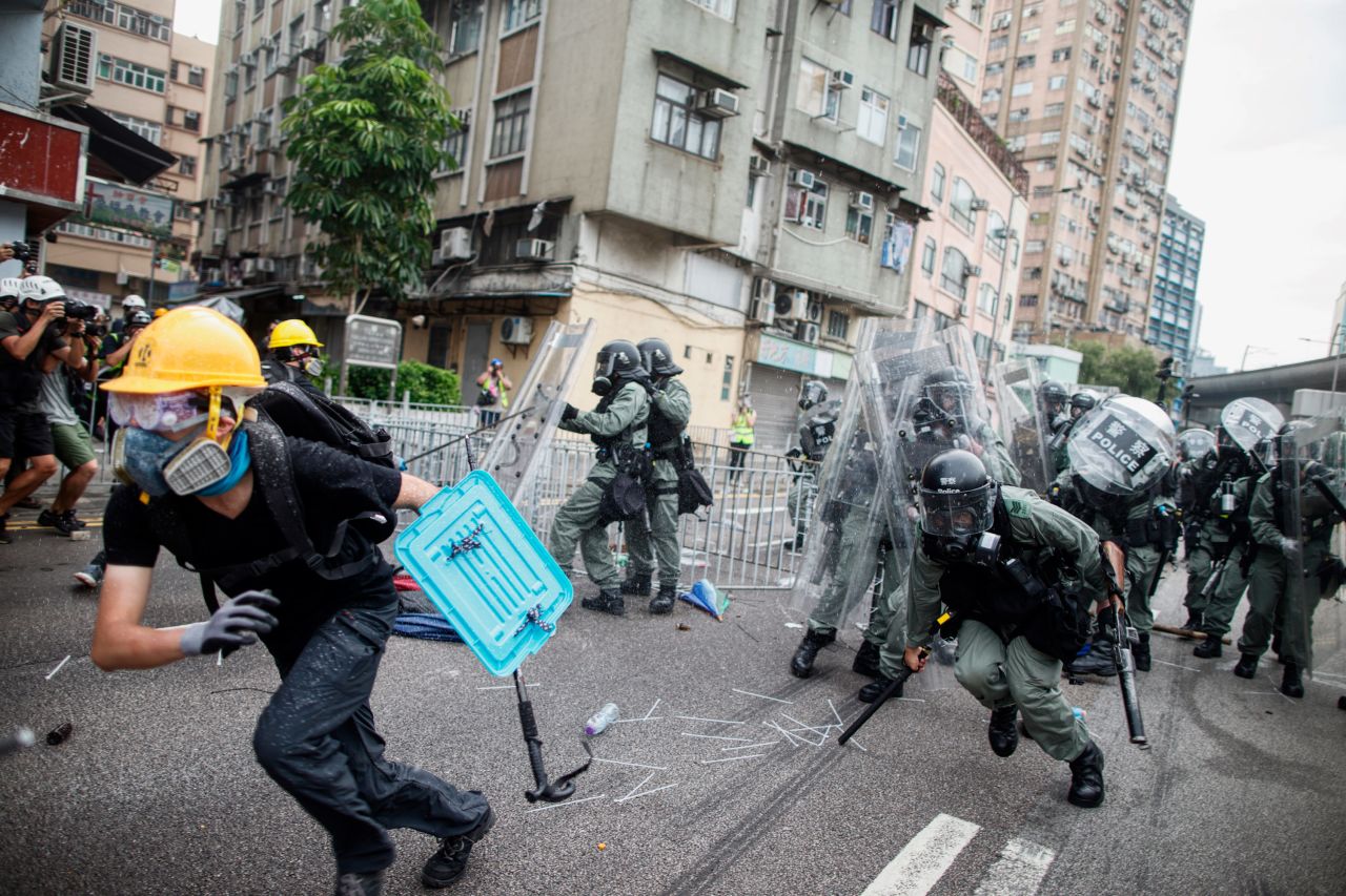 A protester flees from baton-wielding police in the Yuen Long district of Hong Kong on Saturday, July 27.