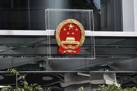 The emblem on the China Liaison Office is protected by plexiglass during a demonstration on Sunday, July 28.