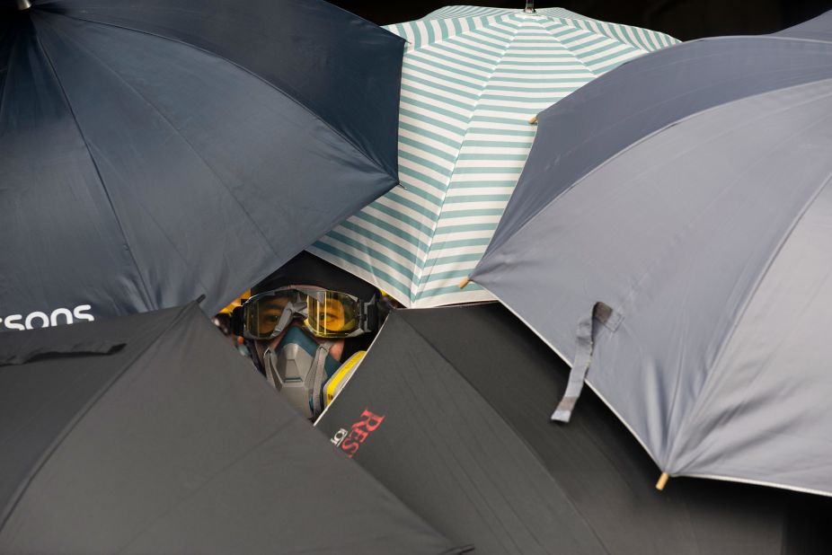 A protester looks through umbrellas during the clashes with police on July 27.