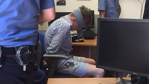Gabriel Hjorth, one of two Americans arrested over the killing of an Italian police officer in Rome, is pictured blindfolded in a police station. Italian police have confirmed to CNN that an investigation has been launched into who leaked the photo to respected Italian newspaper Corriere della sera.