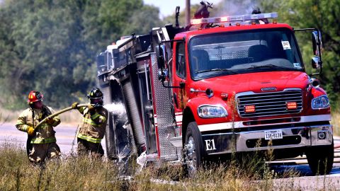 Firefighters hose down a Snyder Volunteer Fire Department truck that caught fire on Thursday.