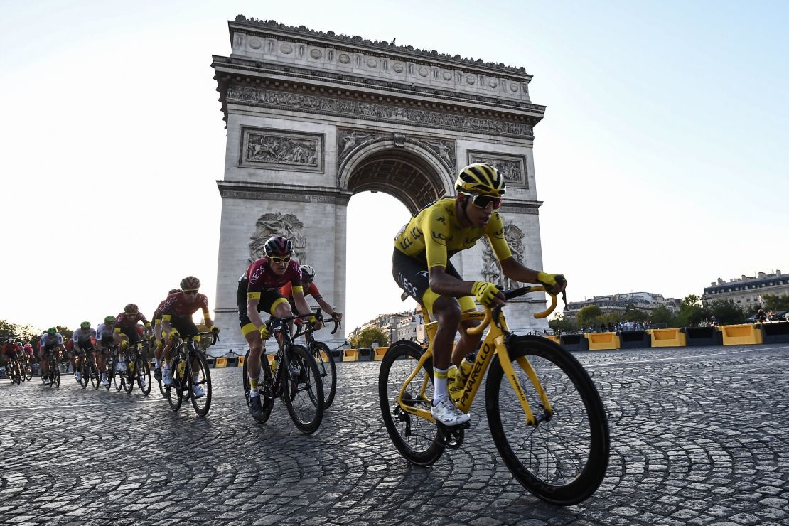 Colombia's Egan Bernal rides down the Champs Elysees alongside the Arc de Triomphe.