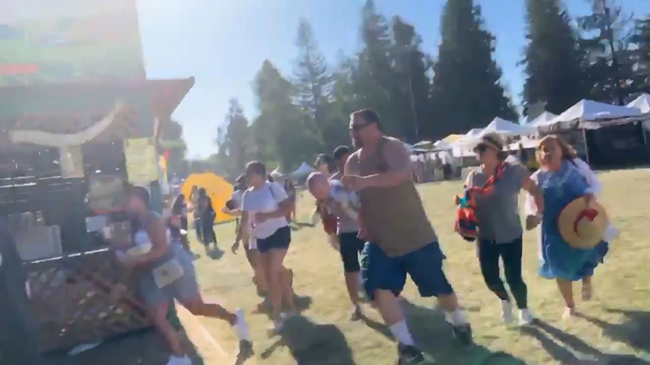 In this image, taken from a video posted on social media, people are seen running as an active shooter is reported at the festival.