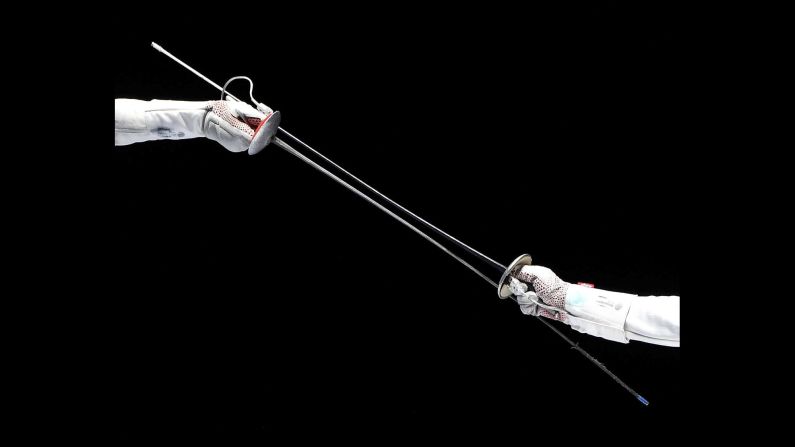 Lee Kiefer of the United States, left, fights against Anita Blaze of France during their third place match of the women's foil team competition at the FIE World Fencing Championships in Budapest, Hungary, on Monday, July 22.<br /><a href="index.php?page=&url=https%3A%2F%2Fwww.cnn.com%2F2019%2F07%2F22%2Fsport%2Fgallery%2Fwhat-a-shot-sports-0721%2Findex.html" target="_blank">See 28 Sports photos from last week</a>