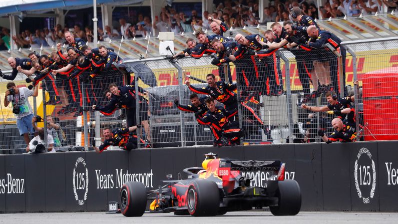 Red Bull's Max Verstappen crosses the finish line to win the F1 German Grad Prix as his team celebrates in Hockenheim, Germany, on Sunday, July 28.
