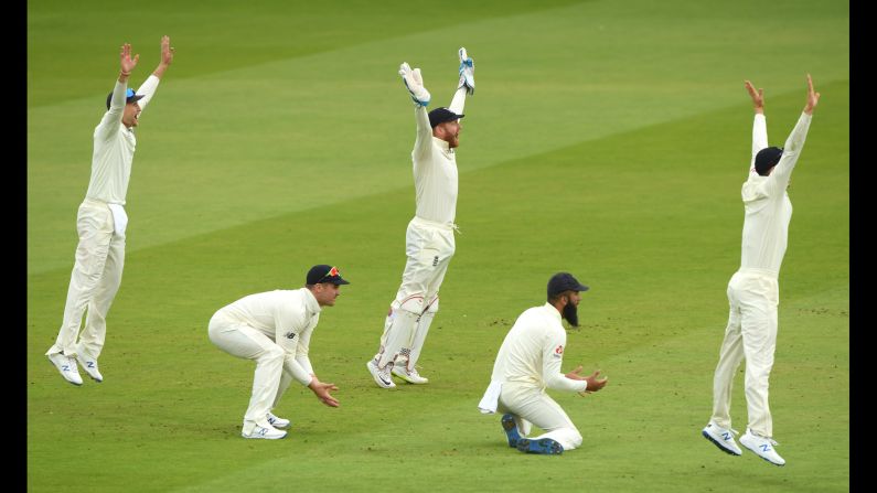 From left, England players Joe Root, Jason Roy, Jonny Bairstow and Moeen Ali appeal for the wicket of Gary Wilson, which is given after review, during a cricket match between England and Ireland at Lord's Cricket Ground in London, England, on Friday, July 26.