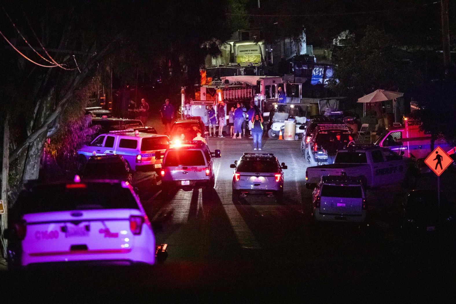 Police vehicles arrive on the scene following a deadly shooting at the Gilroy Garlic Festival on Sunday.