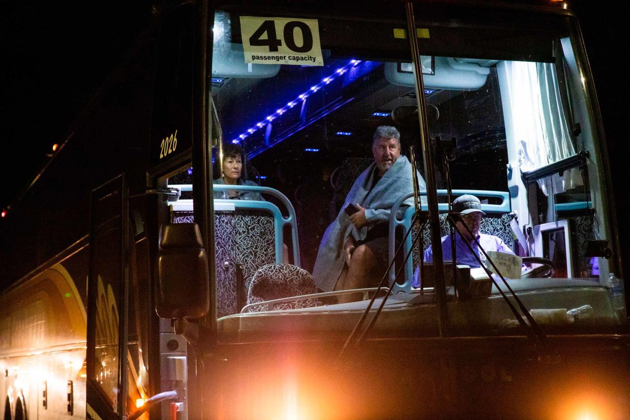 Jane and Edward Jacobucci wait on a chartered bus after leaving the festival area.