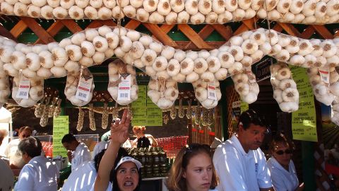 Esperanza Pineda, center left, and Jennifer Smith, center right, sell locally-grown garlic at the Gilroy Garlic Festival in 2004.