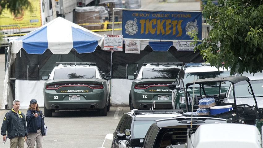 FBI personnel pass a ticket booth at the Gilroy Garlic Festival Monday, July 29, 2019 in Calif., the morning after a gunman killed at least three people, including a 6-year-old boy, and wounding about 15 others.  A law enforcement official identified the gunman, who was shot and killed by police, as Santino William Legan. (AP Photo/Noah Berger)