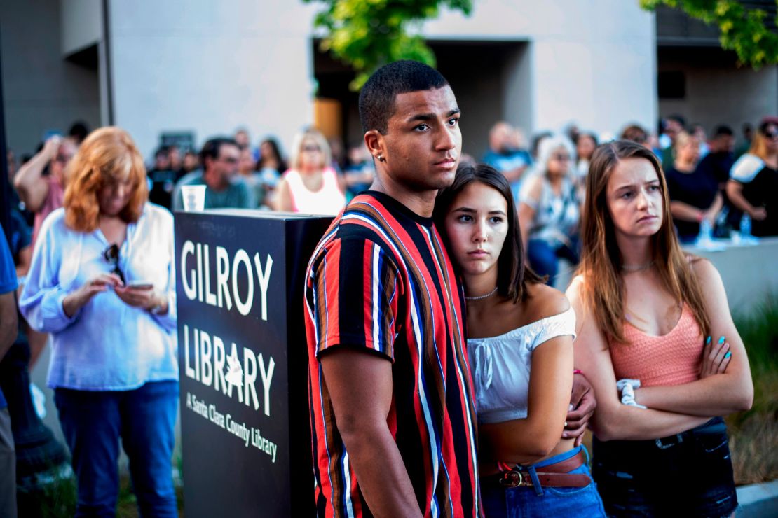 Derrick Smith, left, embraces Sara Sakamoto during a vigil for victims of Sunday's deadly shooting at the Gilroy Garlic Festival on Monday, July 29, 2019.