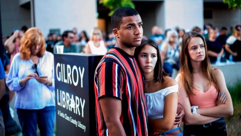 Derrick Smith, left, embraces Sara Sakamoto during a vigil for victims of Sunday's deadly shooting at the Gilroy Garlic Festival on Monday, July 29, 2019.