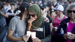 Hina Moheyuddin, left, comforts Noshaba Afzal during a vigil for victims of a Sunday evening shooting that left three people dead at the Gilroy Garlic Festival, Monday, July 29, 2019, in Gilroy, Calif. (AP Photo/Noah Berger)