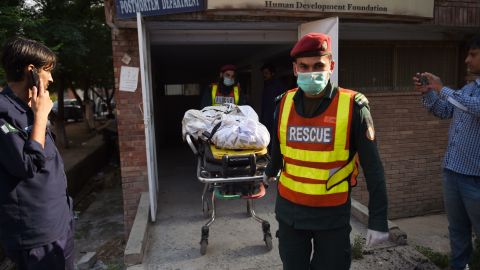 The body of a victim, killed after a Pakistani Army Aviation Corps aircraft crashed into residential buildings, is wheeled on a stretcher at hospital in Rawalpindi on July 30.