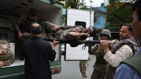 A wounded Afghan man is brought on a stretcher to an Italian aid organisation hospital as Afghan security forces battled an ongoing attack by Taliban militants on a compound housing an international aid organisation in Kabul on May 8, 2019.