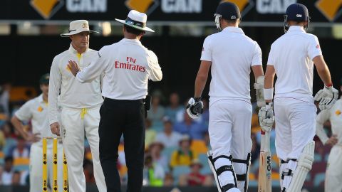 Michael Clarke of Australia speaks to Umpire Aleem Dar as James Anderson of England looks on after a verbal altercation.