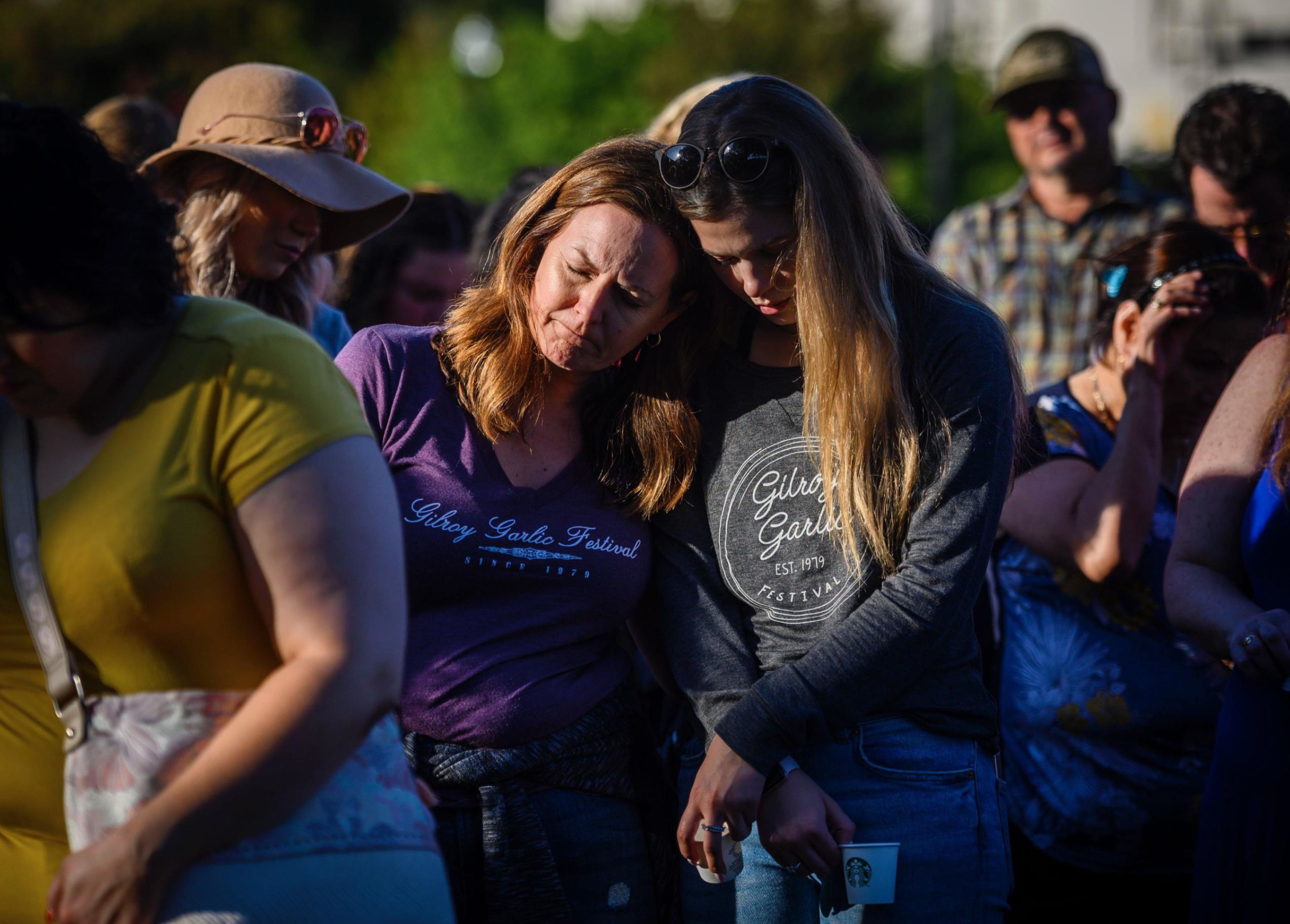 Kirstin Bright, left, leans on Jessica Bright during a vigil at the Gilroy Police Department in California on Monday, July 29. Kirstin was at the Gilroy Garlic Festival during the deadly shooting on Sunday.