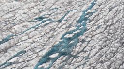 Melt water on the Greenland ice sheet. The Greenland ice sheet (Sermersuaq in Greenlandic) is a vast body of ice covering 1,710,000 square kilometers (660,000 sq mi), roughly 80% of the surface of Greenland. The thickness is generally more than 2 km (1.2 mi) and over 3 km (1.9 mi) at its thickest point. This section of the ice sheet was photographed on the Western part, close to Ilulissat and the glacier Semeq Kujalleq. Positioned in the Arctic, the Greenland ice sheet is especially vulnerable to climate change. (Photo by: Education Images/Universal Images Group via Getty Images)