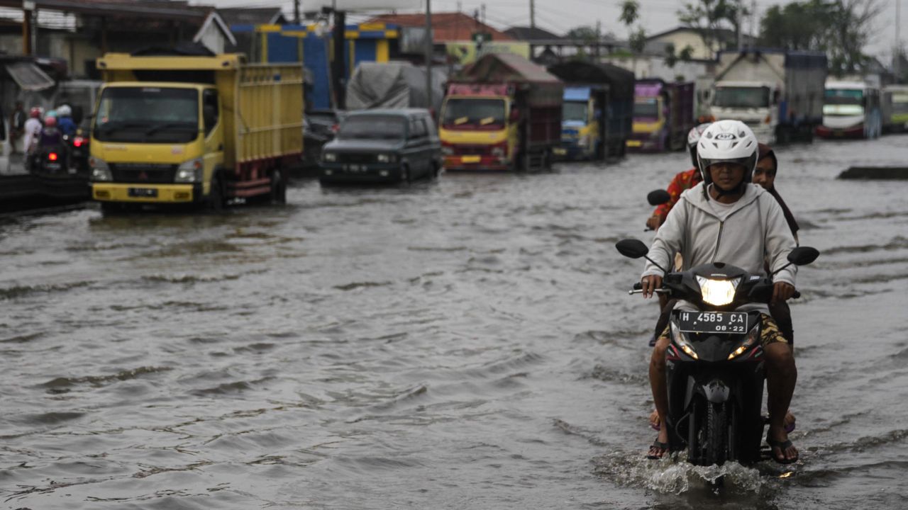 Vehicles in a flood caused by rising sea levels on a highway in Central Java, Indonesia on February 2.