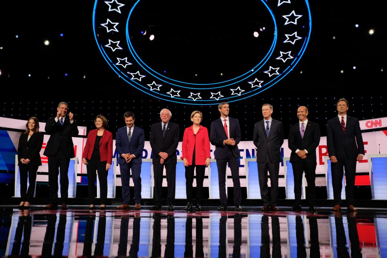 The candidates take the stage at the start of the debate. The candidates, from left, are Williamson, Ryan, Klobuchar, Buttigieg, Sanders, Warren, O'Rourke, Hickenlooper, Delaney and Bullock.