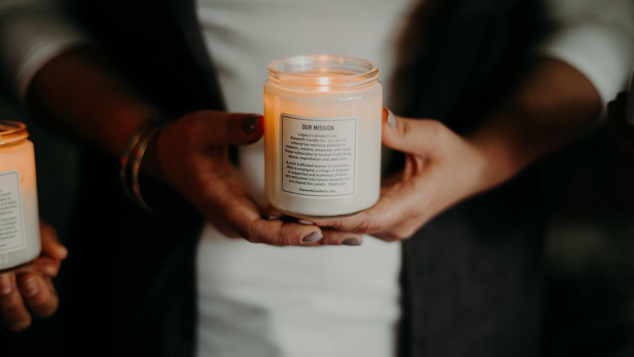 Each candle features a label that explains the social mission behind the company.