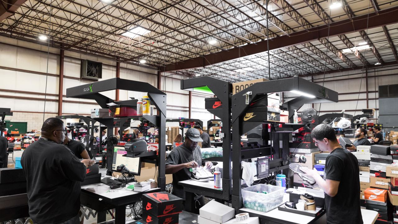 StockX employees examining shoes at a company facility. The startup is based in Detroit, where it recently raised the largest round of venture capital funding ever seen in Michigan.