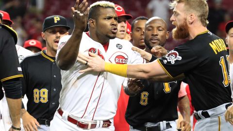 Yasiel Puig is restrained during a bench-clearing altercation in the ninth inning between the Reds and Pirates on Tuesday in Cincinnati.