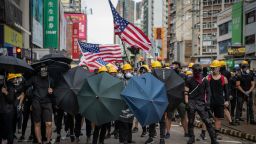 HONG KONG, CHINA - JULY 27: Protesters hold up umbrellas and American flags in the face of advancing riot police in the district of Yuen Long on July 27, 2019 in Hong Kong, China. Pro-democracy protesters have continued weekly rallies on the streets of Hong Kong against a controversial extradition bill since 9 June as the city plunged into crisis after waves of demonstrations and several violent clashes. Hong Kong's Chief Executive Carrie Lam apologized for introducing the bill and recently declared it "dead", however protesters have continued to draw large crowds with demands for Lam's resignation and completely withdraw the bill. (Photo by Laurel Chor/Getty Images)