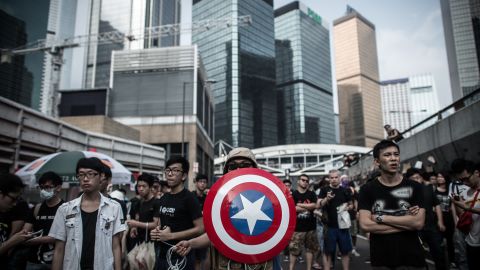 Pro-democracy protesters, including one carrying a shield from the "Captain America" comic book series stand their ground during protests in Hong Kong on October 4, 2014.