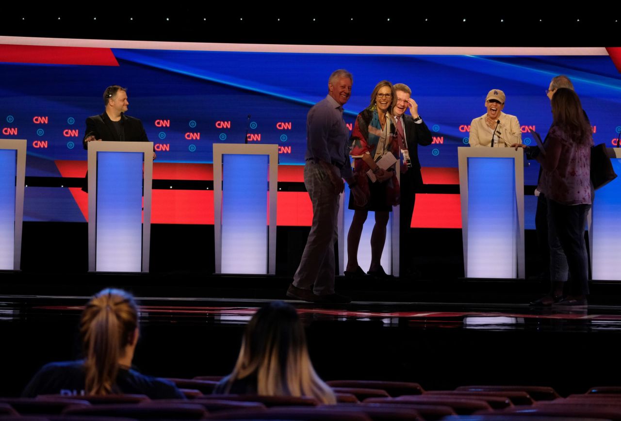 Harris, in the baseball cap, laughs during a debate walkthrough earlier on Wednesday. She was looking out at people who were sitting in her family's seats.