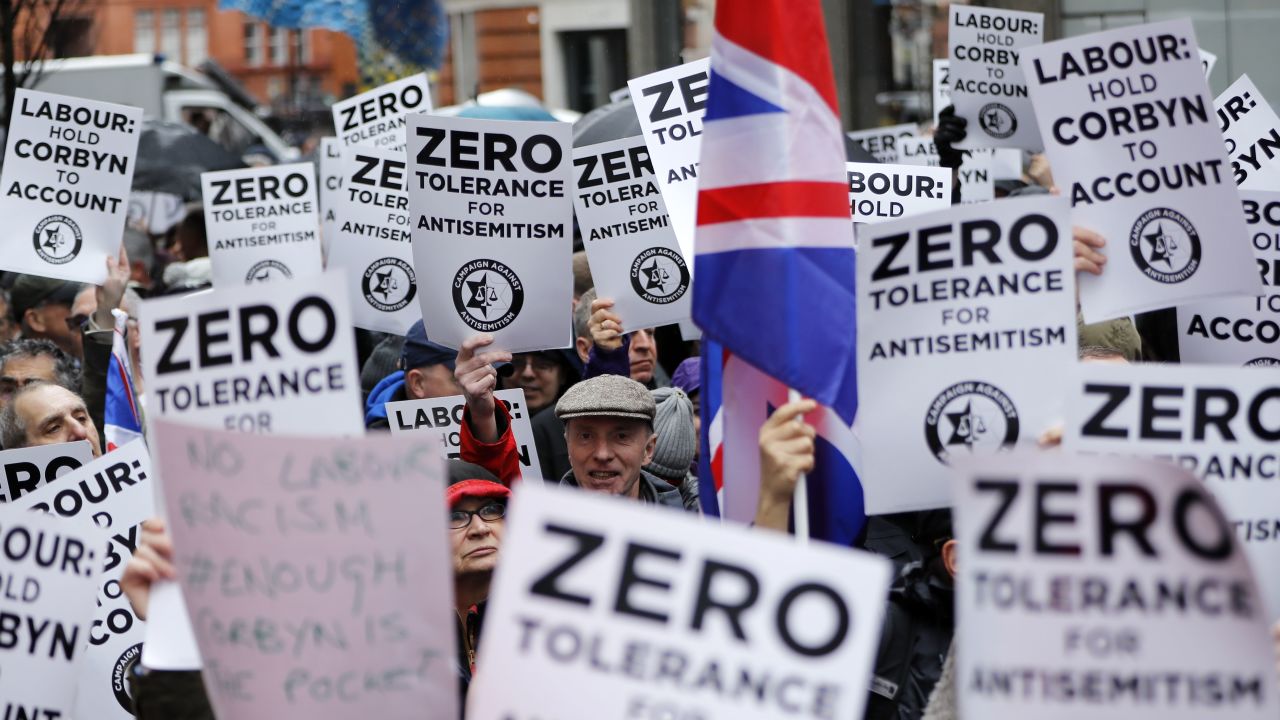 People gather for a demonstration organized by the Campaign Against Antisemitism outside the head office of the British opposition Labour Party in central London on April 8, 2018. 