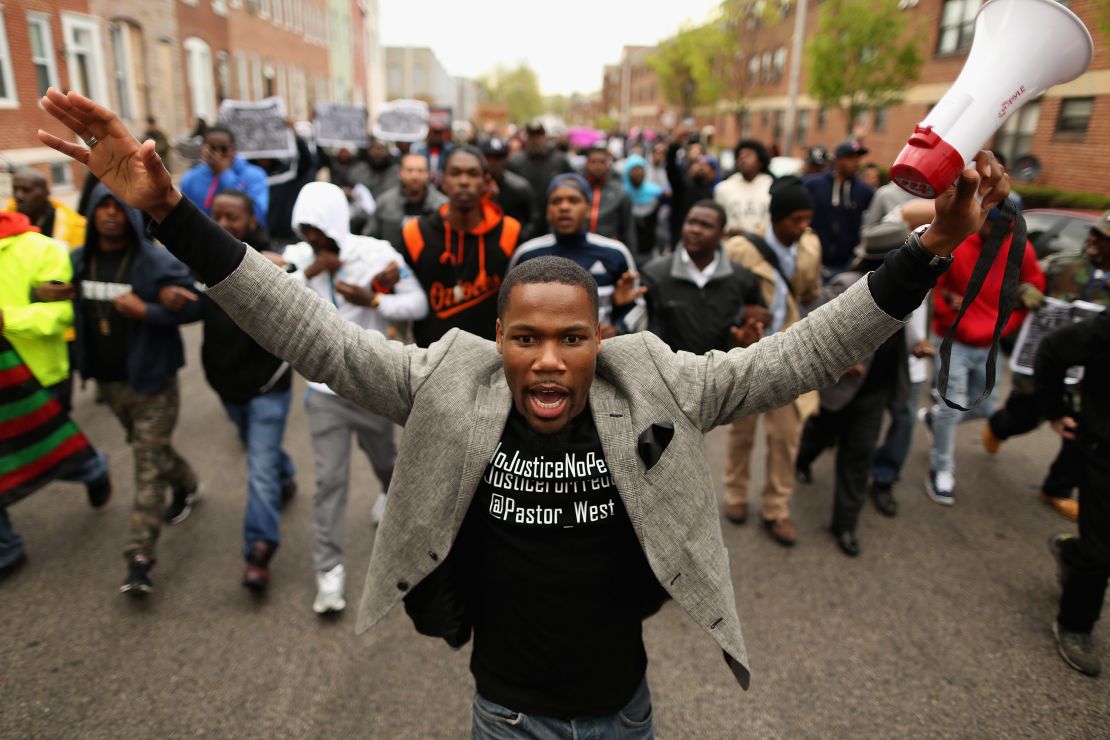 Demonstrators march toward a West Baltimore police station during a protest after the death of Freddie Gray in  April  2015.