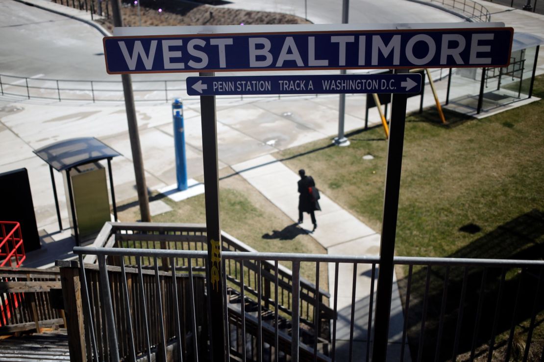 A woman walks from the West Baltimore train station on March 26, 2018. 