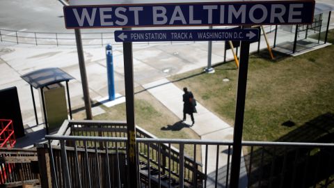 A woman walks from the West Baltimore train station on March 26, 2018.