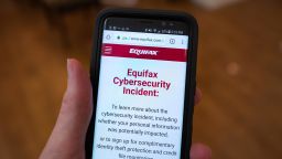 Close-up of the hand of a man holding a mobile phone open to the web site of credit bureau Equifax, with text on the website reading "Equifax Cybersecurity Incident", providing steps for consumers to take following a security breach at the company, San Ramon, California, September 28, 2017. (Photo by Smith Collection/Gado/Getty Images)
