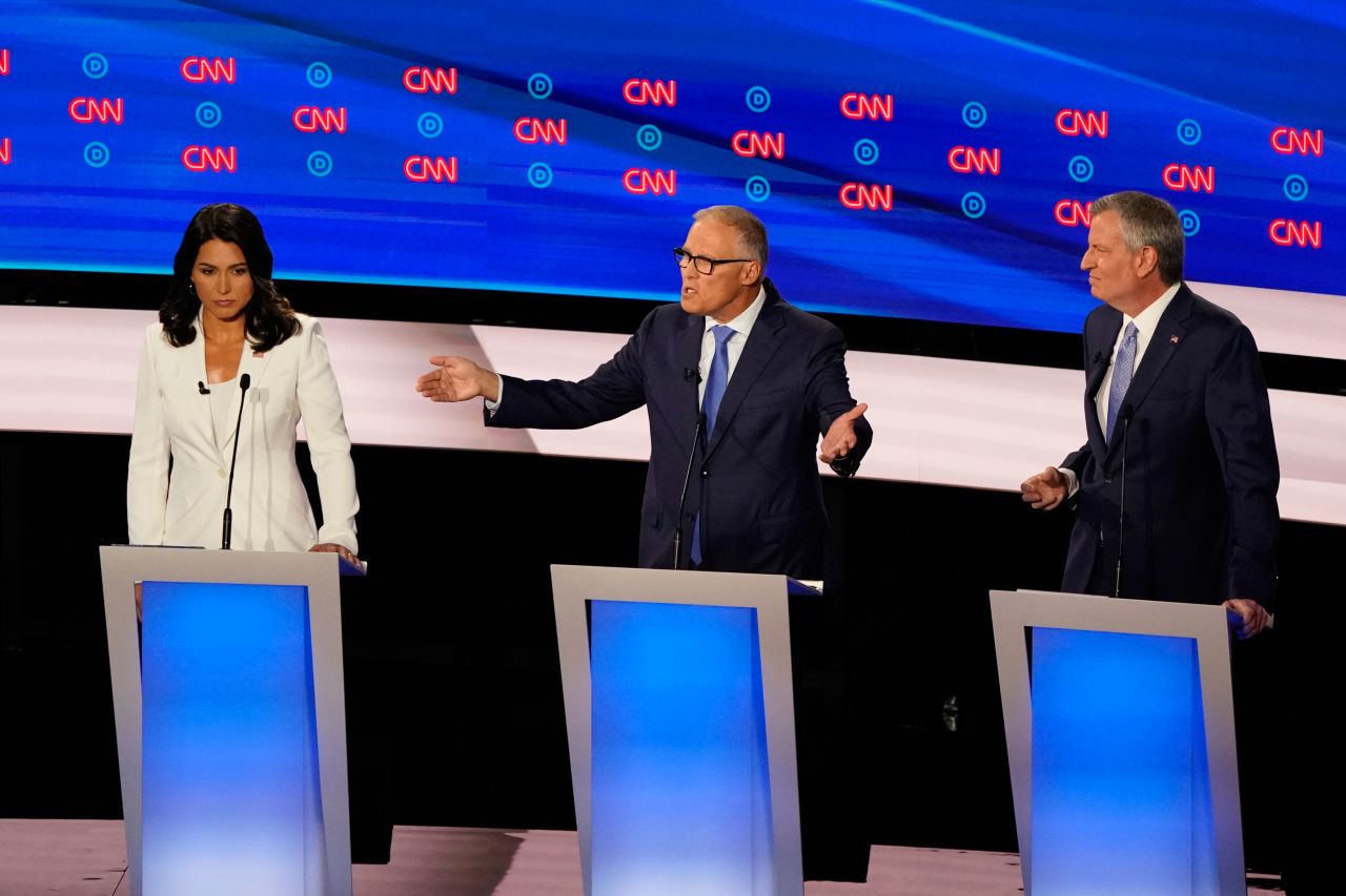From left, Gabbard, Inslee and de Blasio participate in Wednesday's debate.  Inslee began his run as a one-issue candidate focused on climate change. "The time is up," Inslee said. <a href="https://www.cnn.com/politics/live-news/democratic-debate-july-31-2019/h_b53ac5038556ee8fa3e5f7388e965e02" target="_blank">"Our house is on fire."</a>
