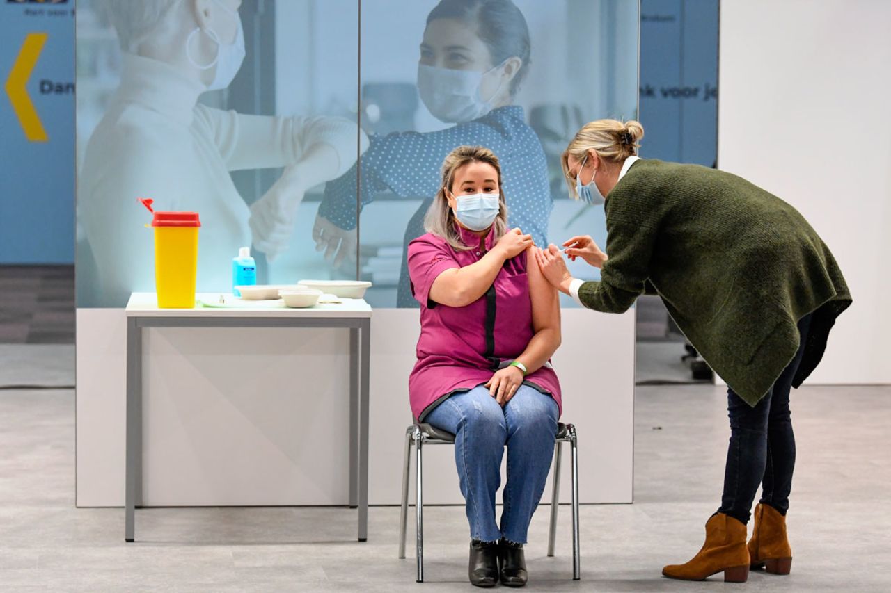 Healthcare worker Sanna Elkadiri, left, was the first Dutch recipient of a shot of the Pfizer-BioNTech coronavirus vaccine at a mass vaccination center in Veghel, Netherlands on January 6.