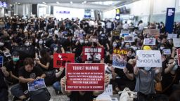Demonstrators hold placards in the arrival hall during a protest at the Hong Kong International Airport in Hong Kong, China, on Friday, July 26, 2019. Hundreds of protesters staged a sit-in at Hong Kongs main international airport terminal on Friday, the first of three straight days of demonstrations after clashes last week triggered fears that a wider confrontation could erupt in the Asian financial hub. Photographer: Justin Chin/Bloomberg via Getty Images