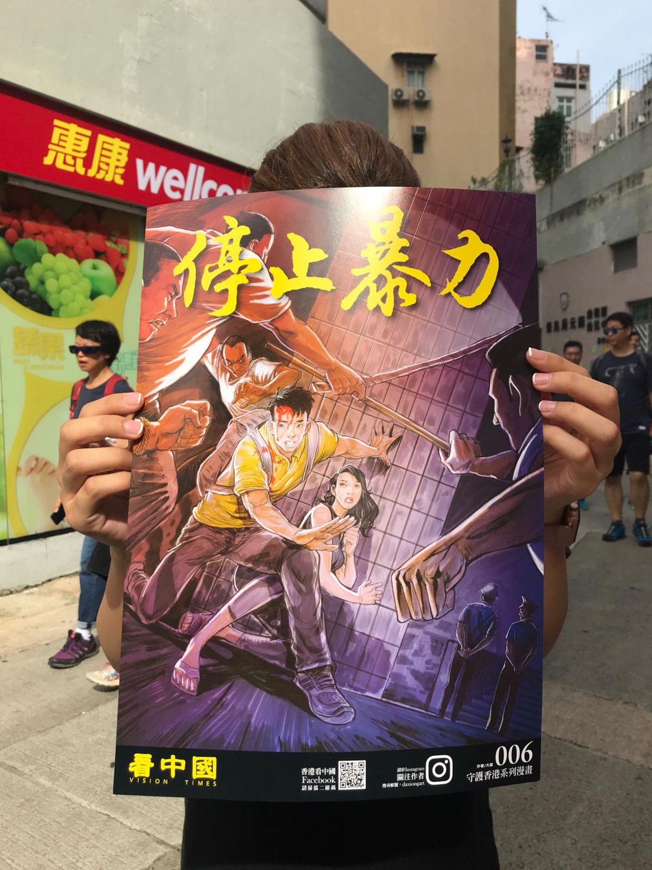 A protester holds up an anime-inspired poster. 