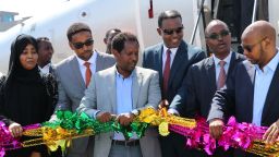 Mayor of Mogadishu, Abdirahman Omar Osman (3rd L), and CEO of Ethiopias National Airways, Abera Lemi (3rd R), celebrate after the first commercial flight by National Airways linking Addis Ababa to Mogadishu in 41 years landed at Aden Abdulle international airport in Mogadishu, on October 13, 2018. - The airline will operate four flights a week between the two capitals. (Photo by Abdi Hussein FARAH / AFP)        (Photo credit should read ABDI HUSSEIN FARAH/AFP/Getty Images)